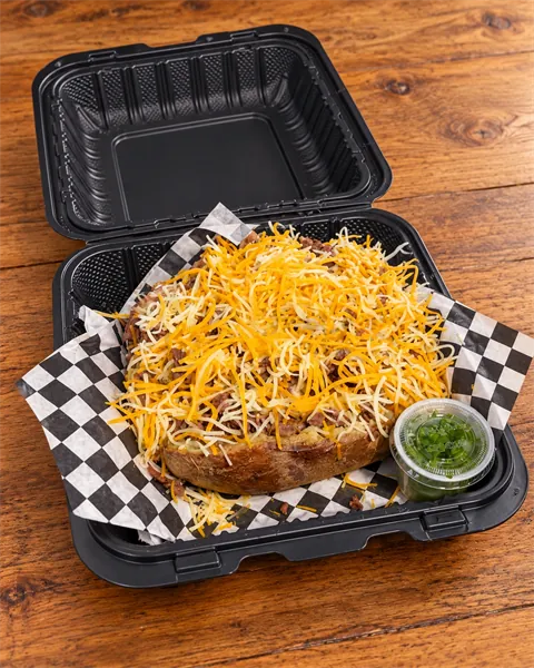 SteakFlo loaded potato topped with seasoned steak and shredded cheese